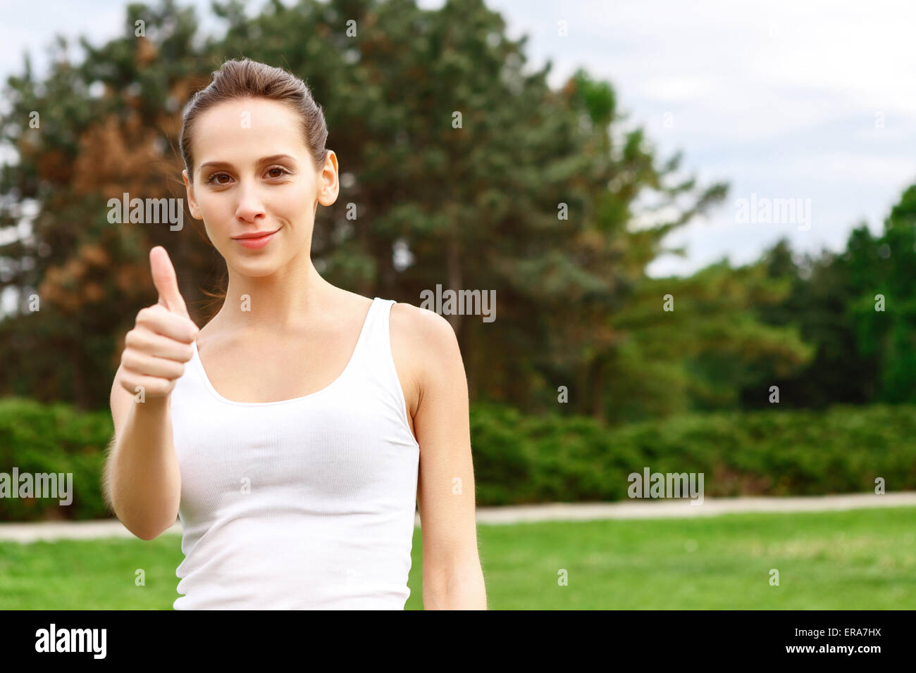 Pretty smiling girl with thumb up Stock Photo - Alamy