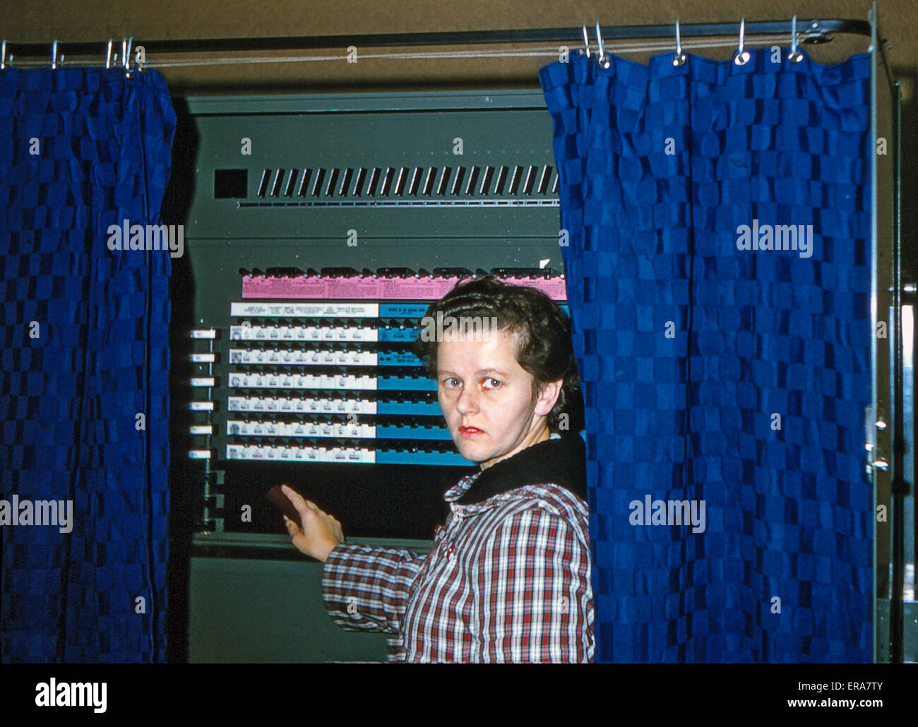 Young woman in a voting booth in the 1964 presidential election. Stock Photo