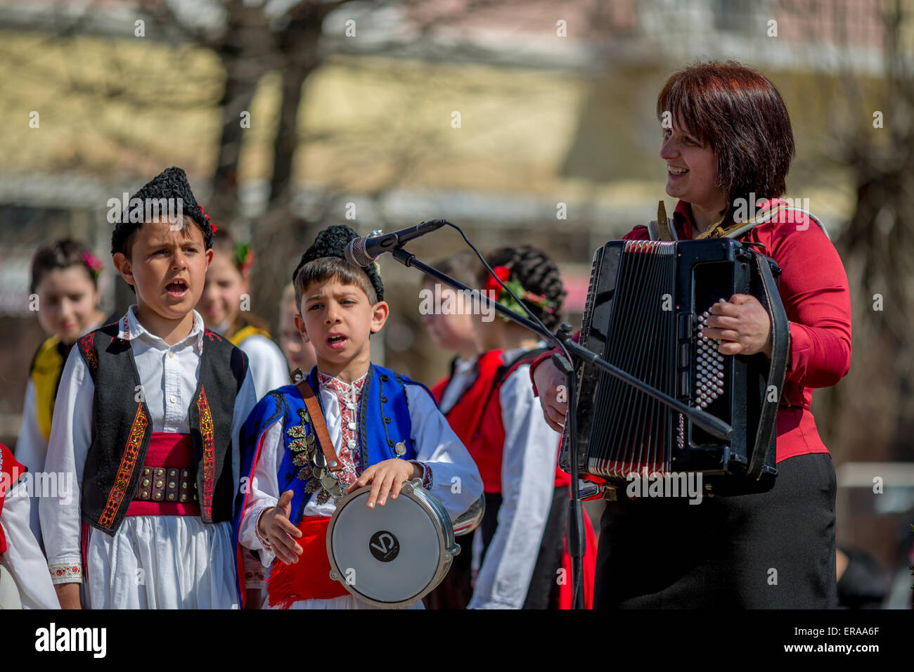 Young Bulgarian folklore singers performing a song with their music ...