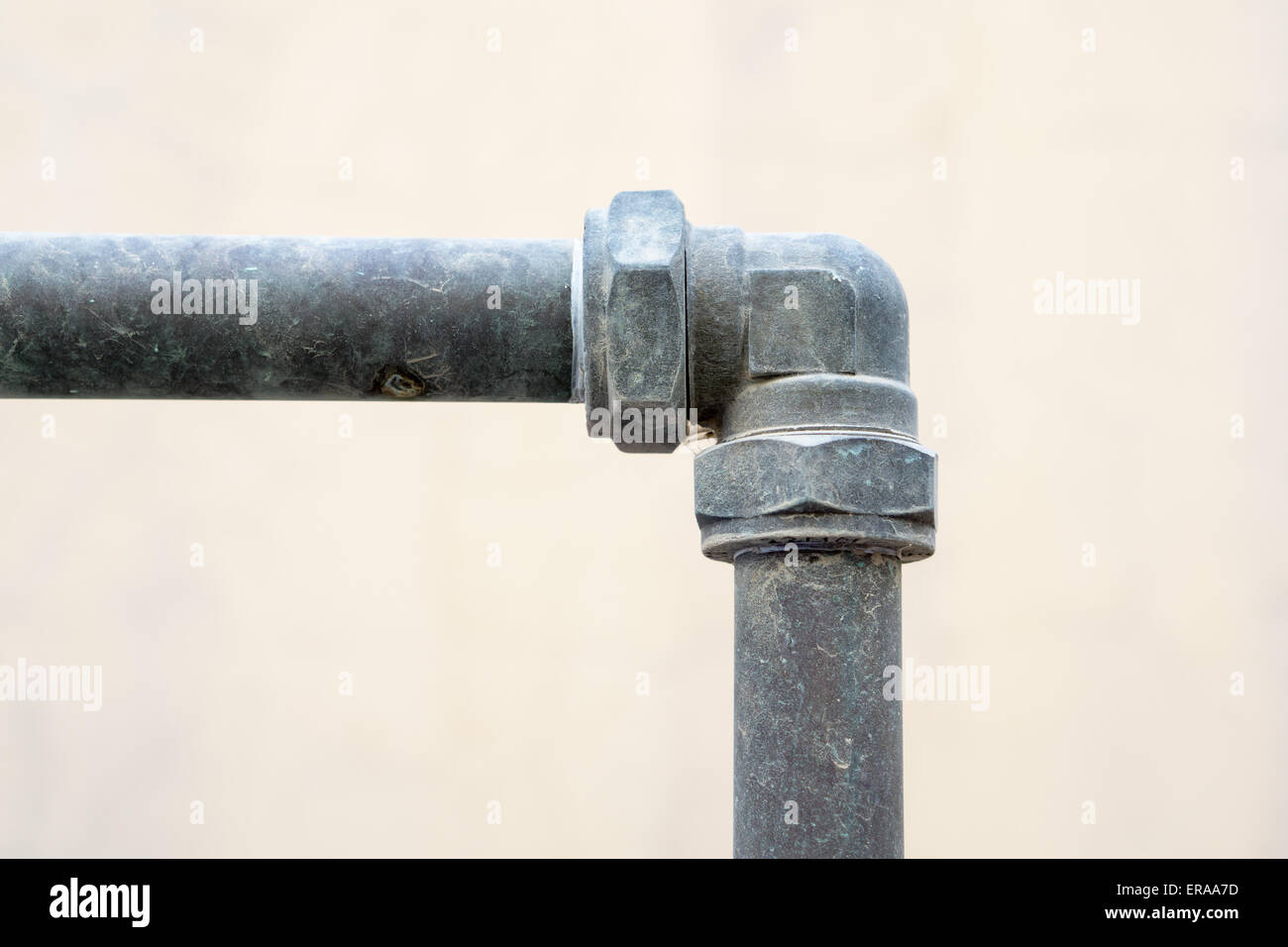 Metallic Water pipe connected with elbow shallow depth of field closeup