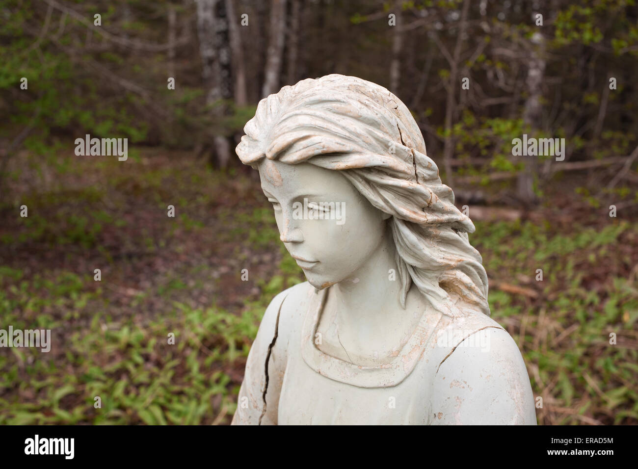 Angel statue portrait in wooded setting. Stock Photo
