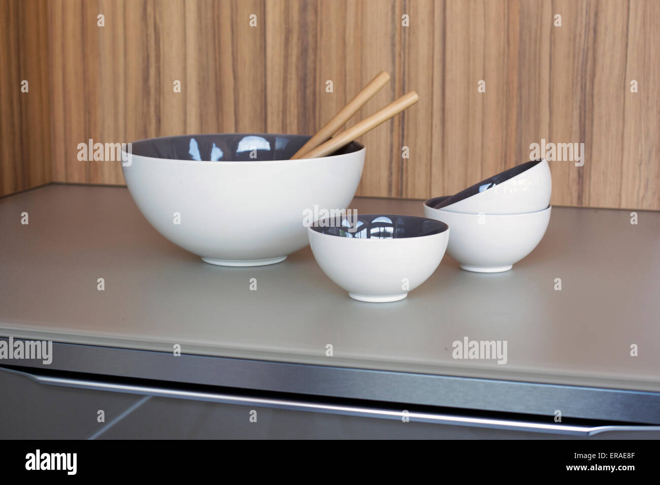 white bowls and cups with wooden spoons on kichen counter Stock Photo