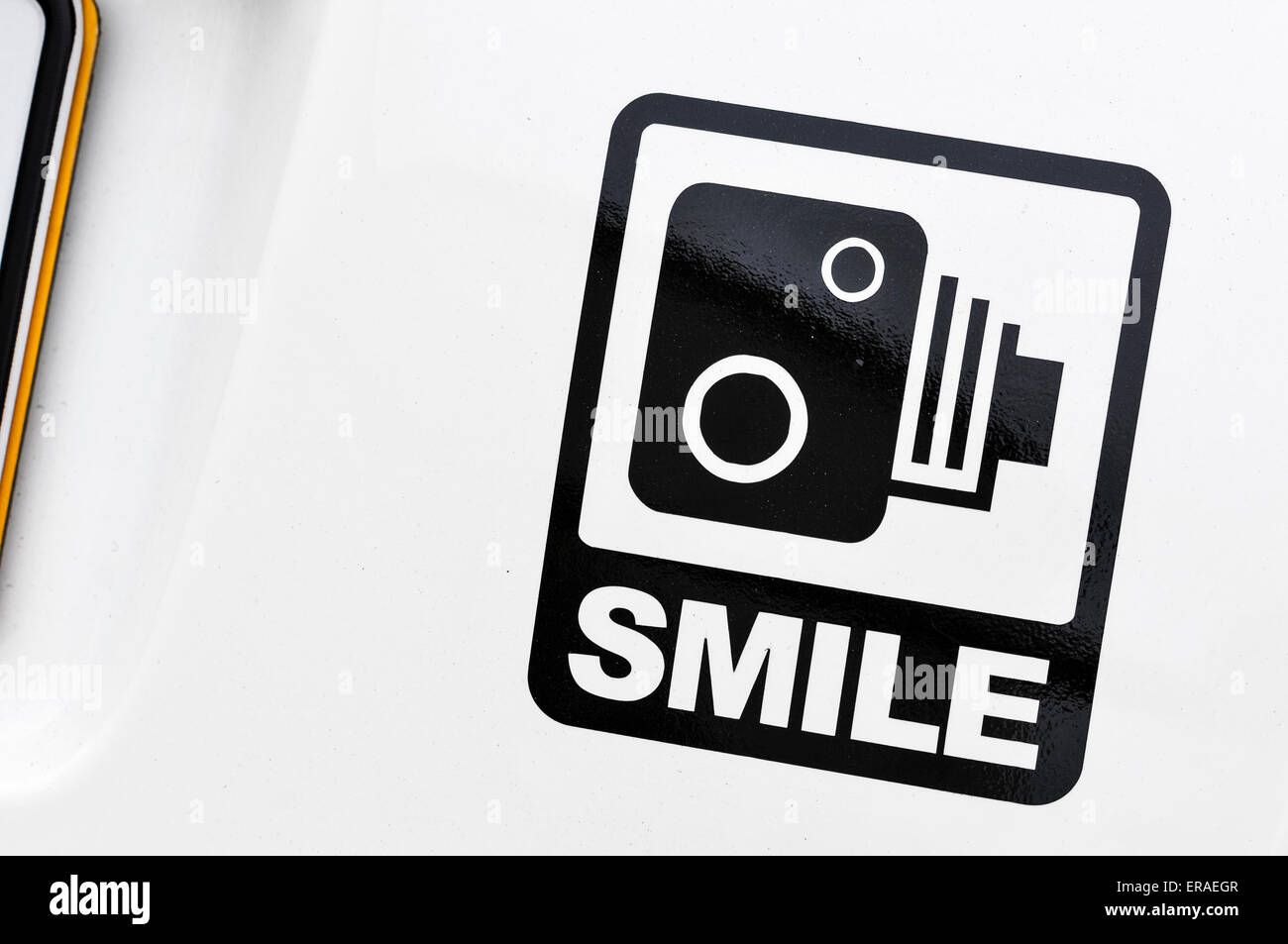 Cheeky sticker on the rear of a car with a speed camera and 'smile'. Stock Photo