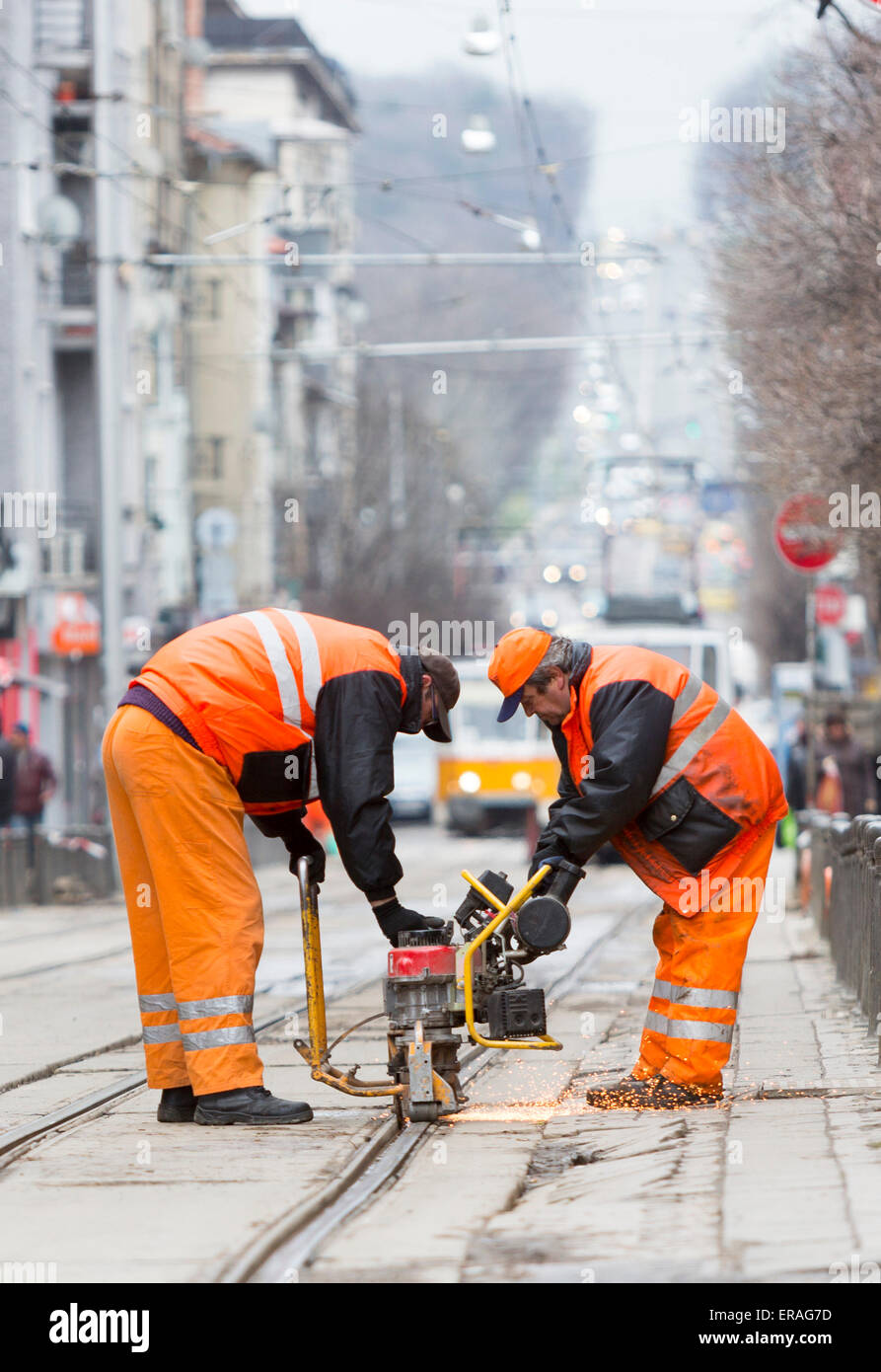 Sofia, Bulgaria - April 7, 2015: Tram road workers are repairing the tram tracks on the tram road. Stock Photo