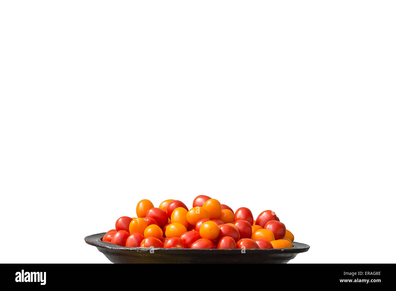 Tomatoes red and yellow on large plate isolated on white. Stock Photo