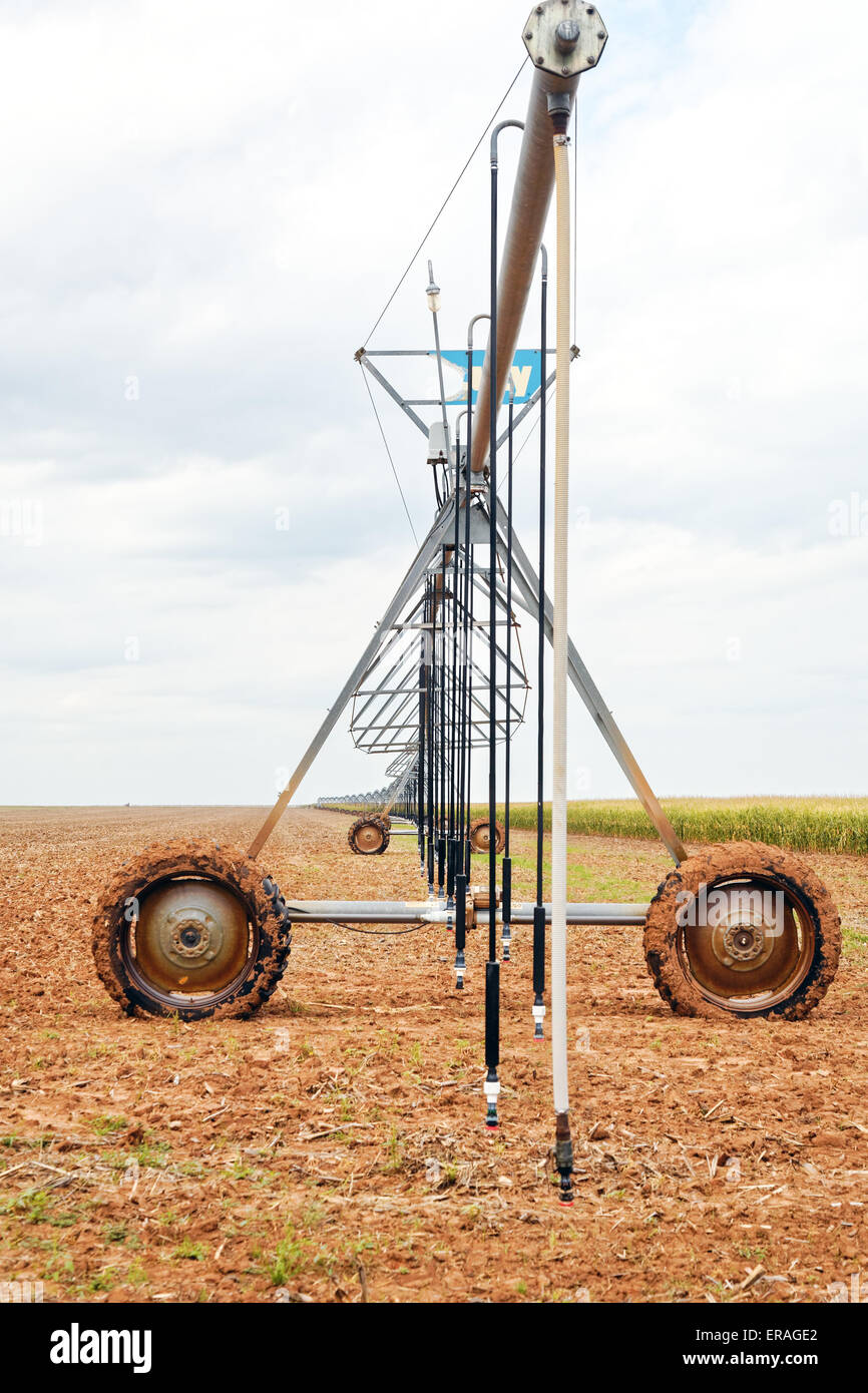Large, wheeled field irrigation system stretching into the distance on