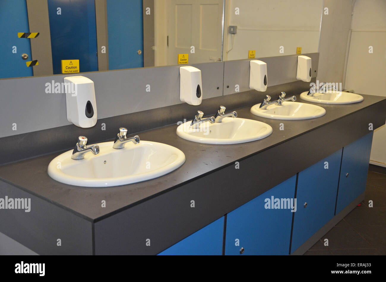 four sinks in a public convenience room Stock Photo