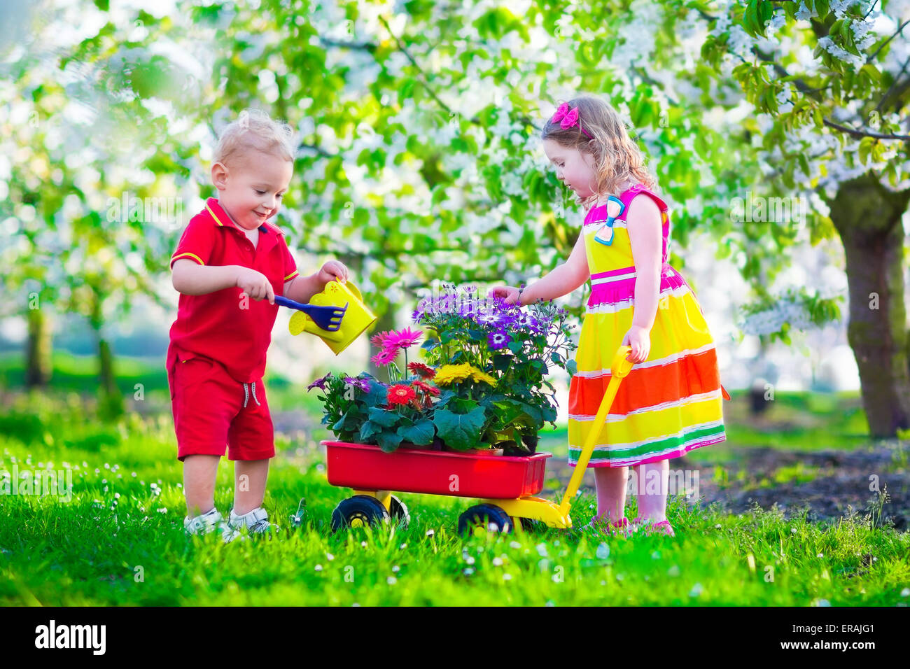 Kids gardening. Children playing outdoors. Little girl and baby boy ...