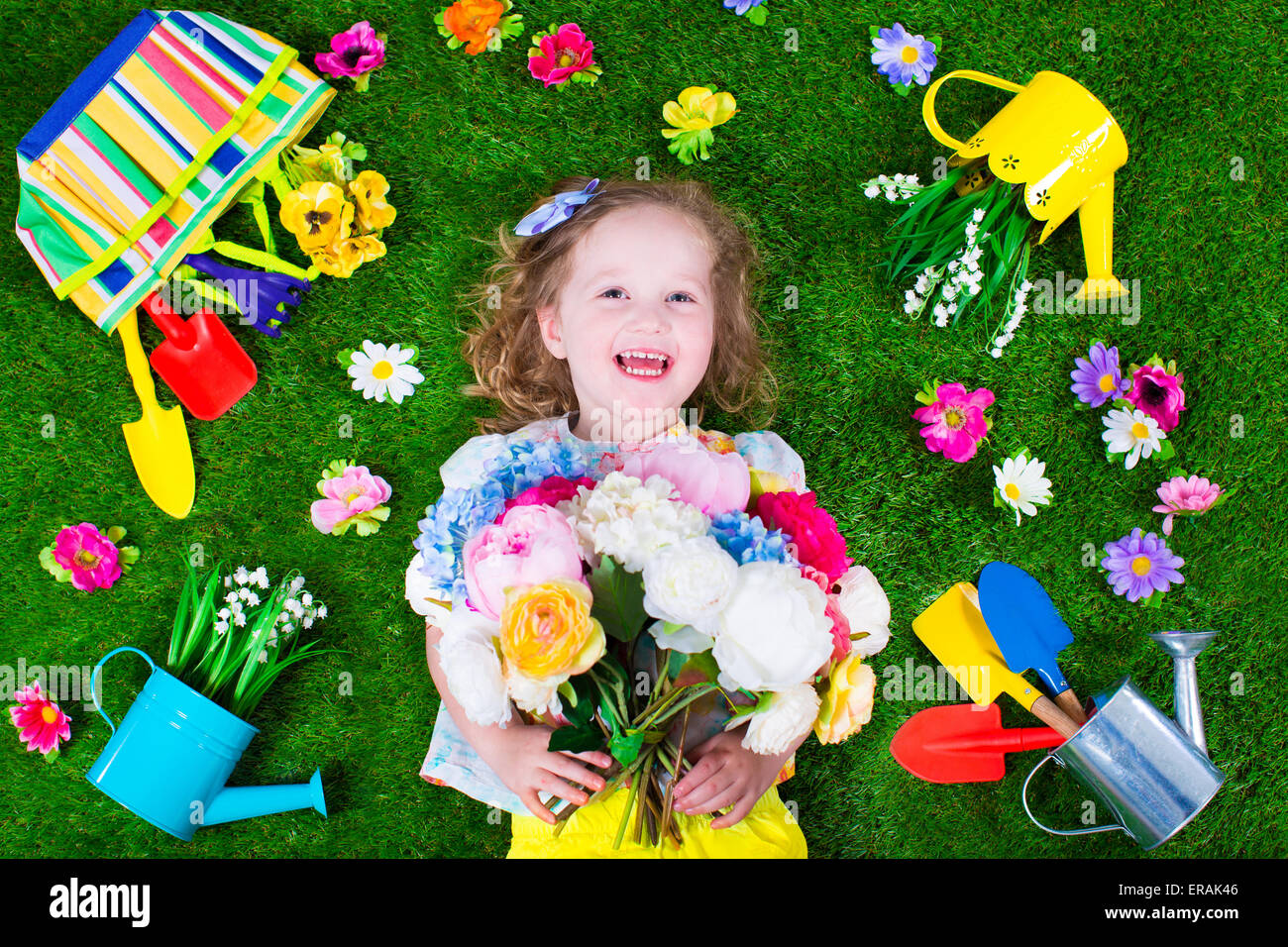 Kids gardening. Children with garden tools. Child with watering can and shovel. Little kid watering flowers. Stock Photo
