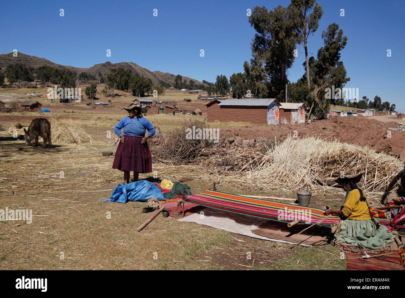 Woman weaving outside home on Capachica Peninsula, Lake Titicaca, Peru Stock Photo