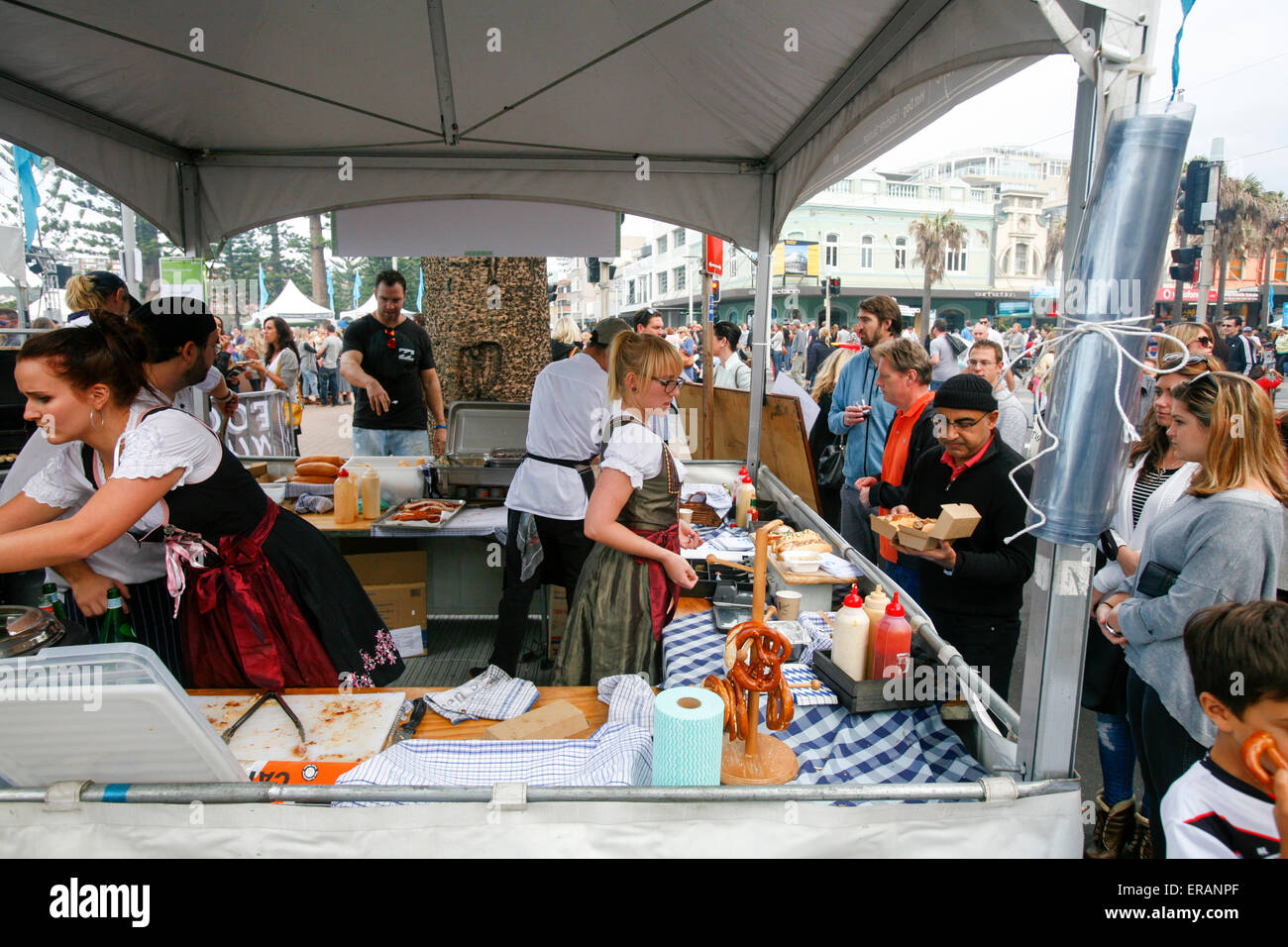 Manly Beach Food,wine and sustainability festival in its 29th year on Manly beach and corso, Sydney, Australia. Here Bavarian beer cafe staff serve beer and sausage to locals and visitors Stock Photo