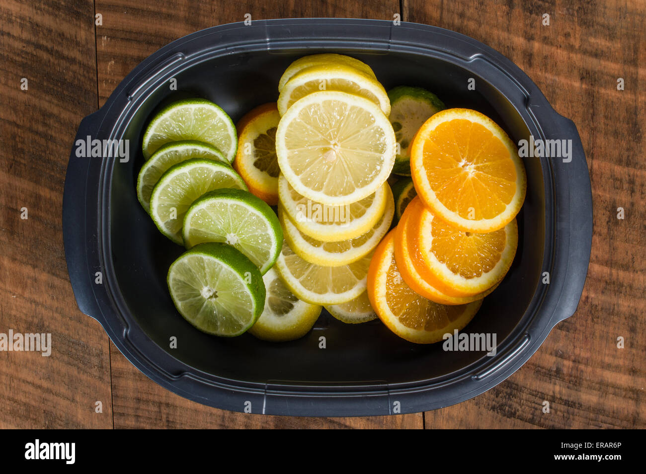 Bowl with lemon, lime and orange slices Stock Photo - Alamy