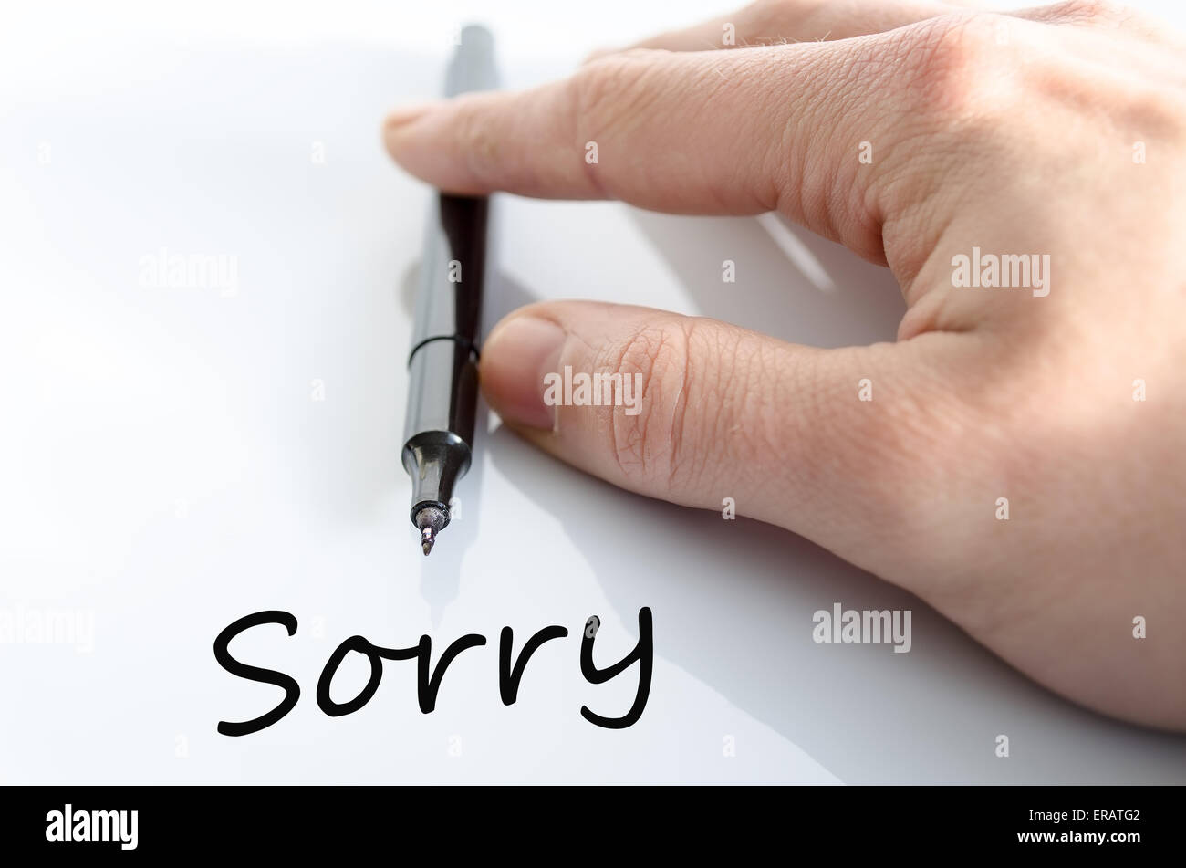 Pen in the hand isolated over white background Sorry Concept Stock ...
