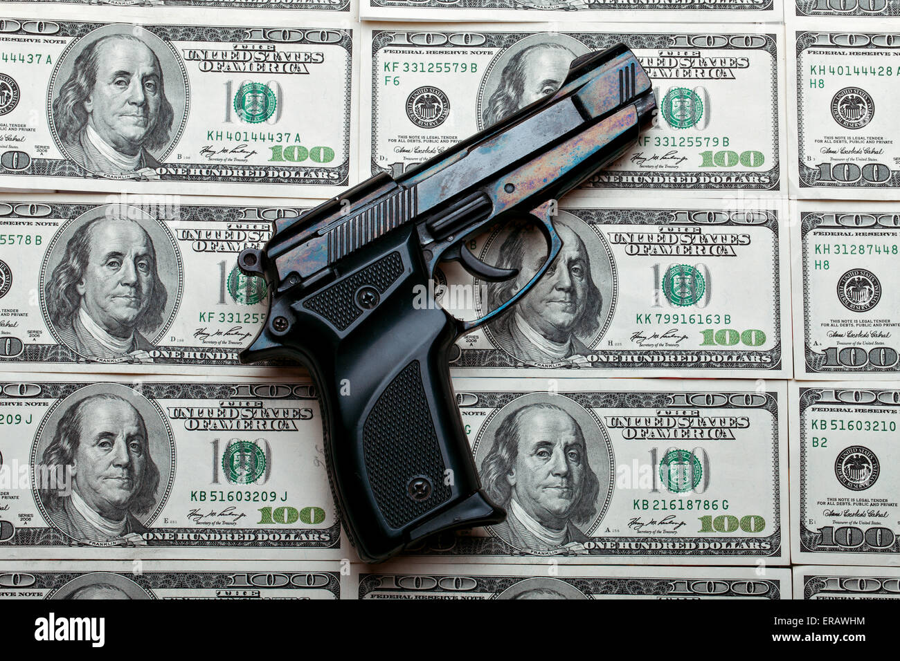 Money and weapons. Gun against the dollar bills Stock Photo Alamy