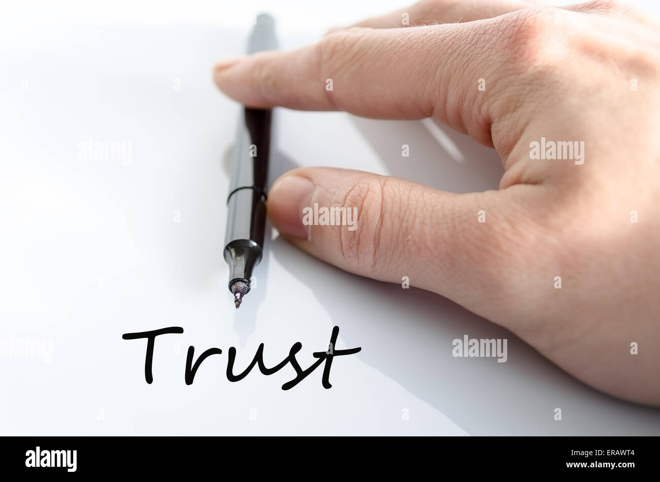 Pen in the hand isolated over white background Trust Stock Photo