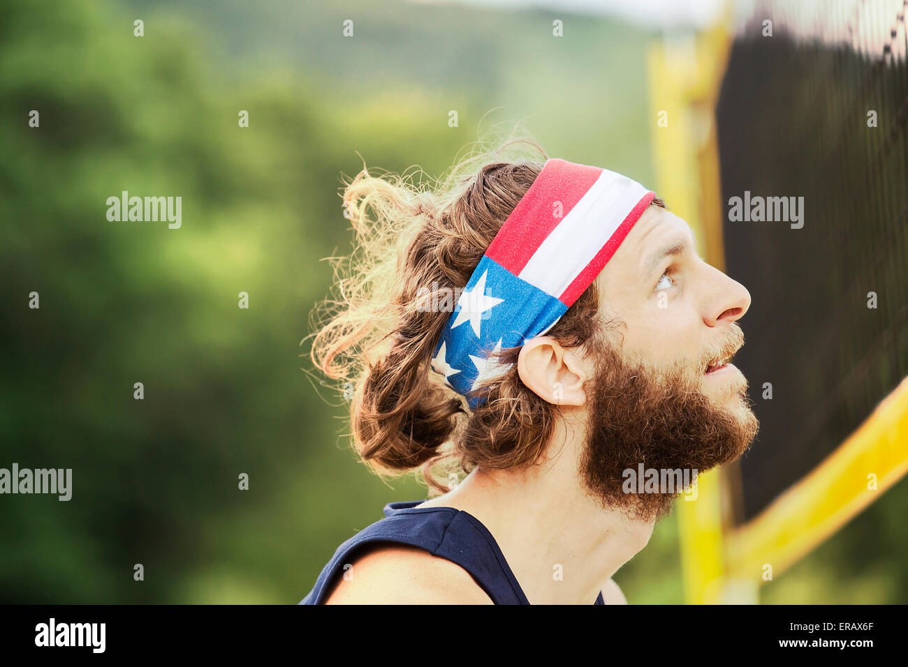 Portrait of natural looking beach volleyball player who is waiting on the net for the ball. Stock Photo