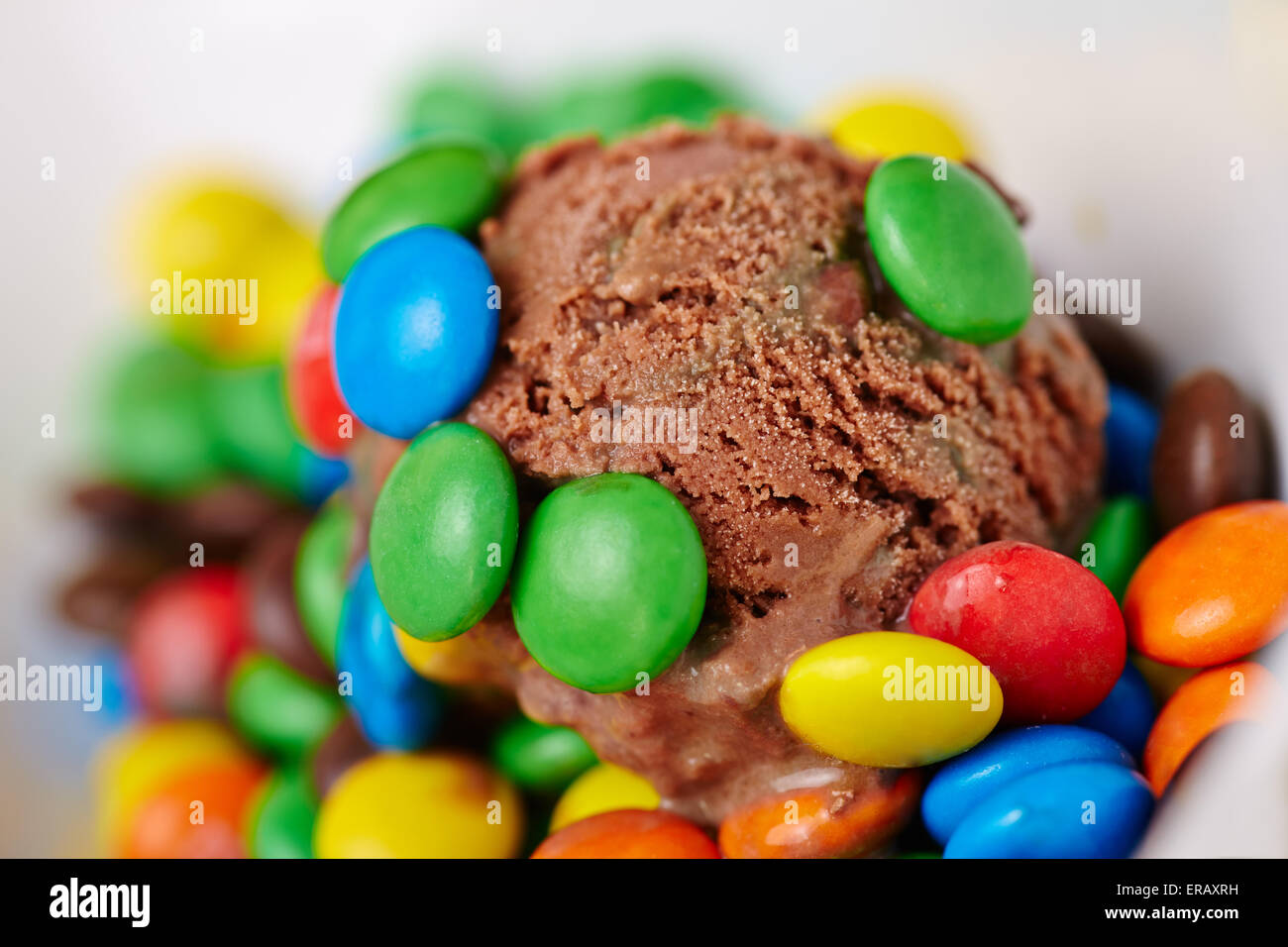 Scoop of homemade chocolate ice cream with colorful chocolate dragees Stock Photo