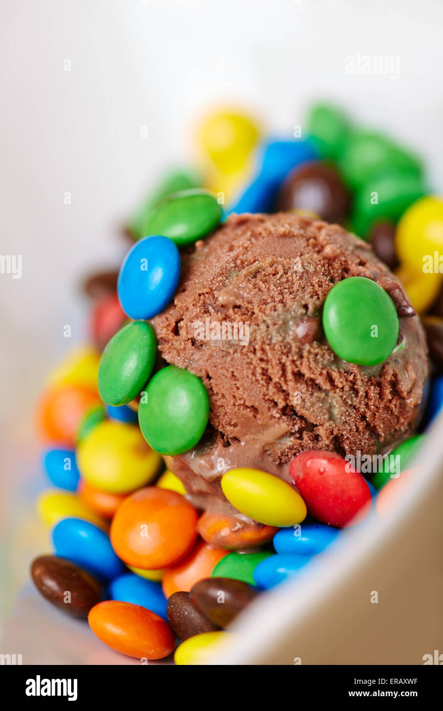 Scoop of homemade chocolate ice cream with many colorful chocolate dragees Stock Photo