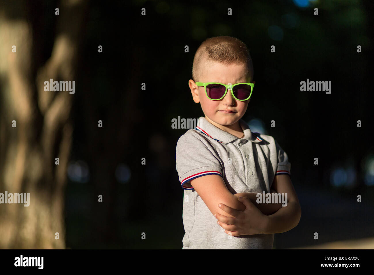 little boy playing on the grass in the summer park Stock Photo