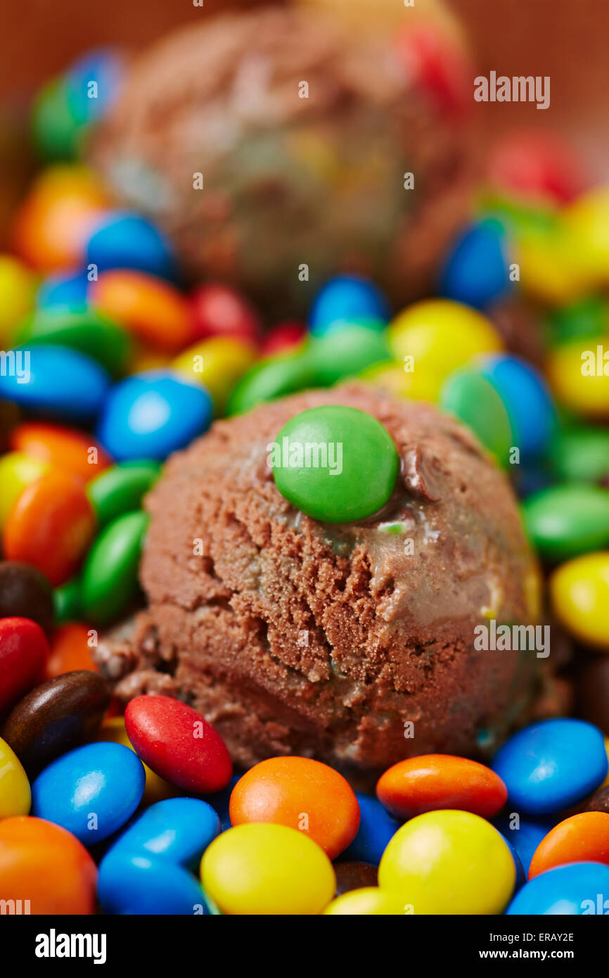 Colorful chocolate beans on chocolate ice cream scoop Stock Photo