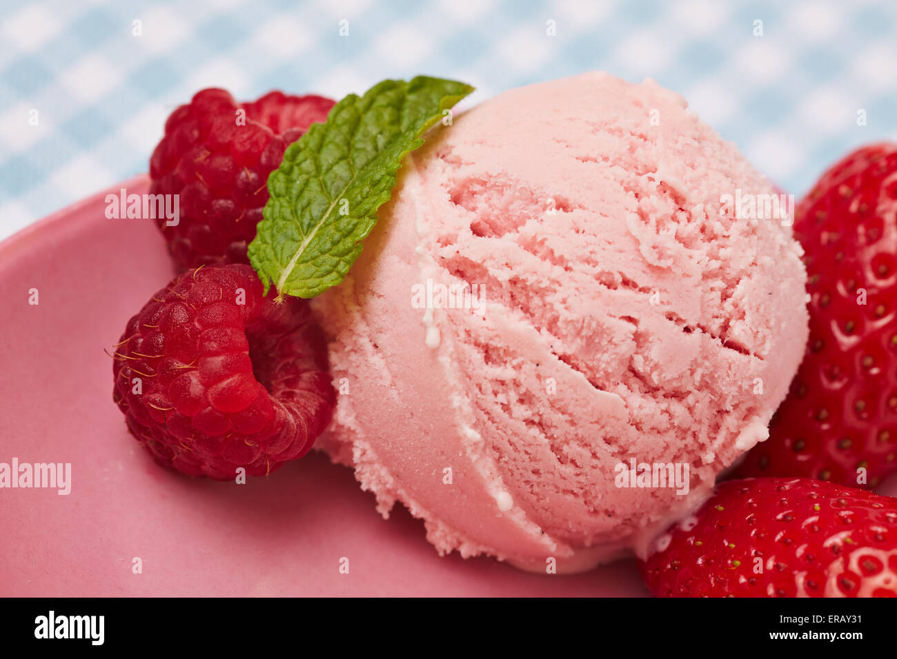 Scoop of homemade strawberry ice cream with fresh peppermint leaf Stock Photo