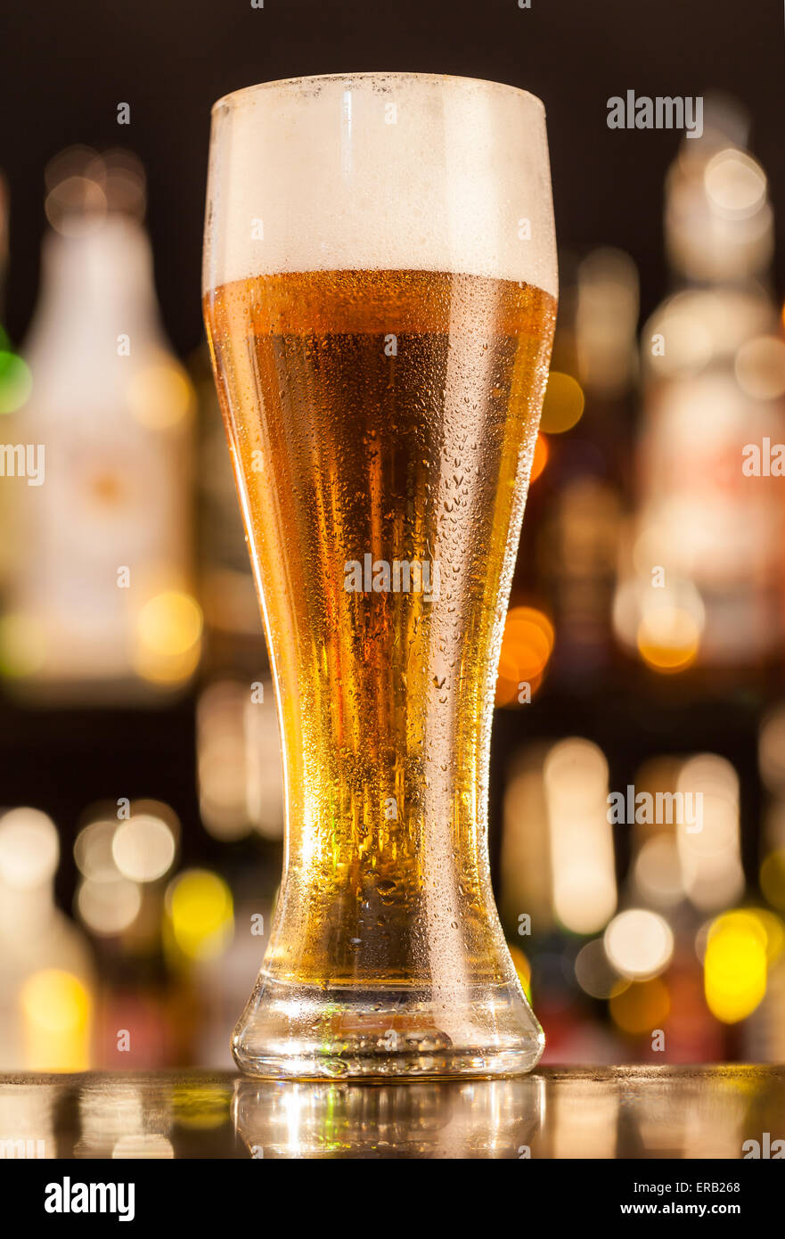 Jug of beer placed on bar counter Stock Photo