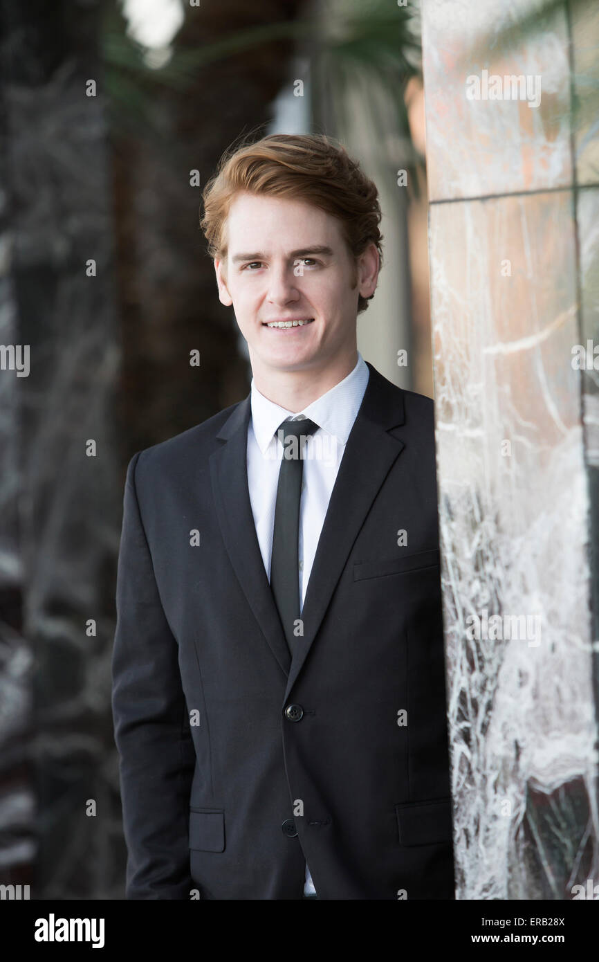 portrait of a businessman standing next to a marble wall Stock Photo