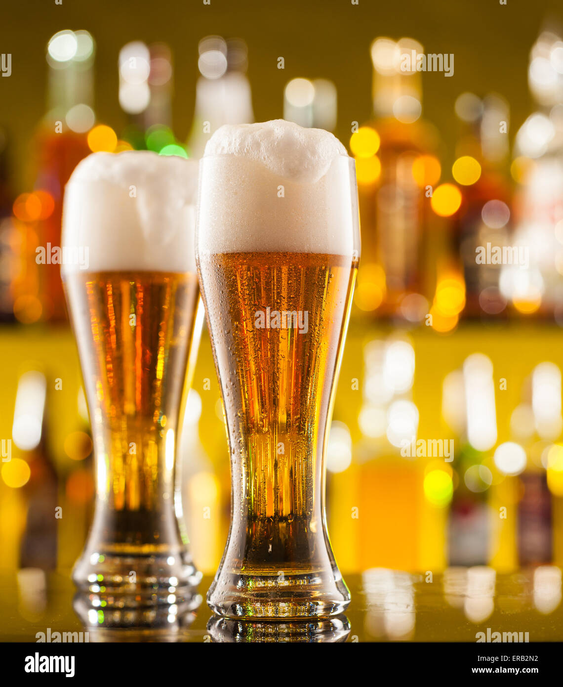 Jugs of beer placed on bar counter with copyspace Stock Photo