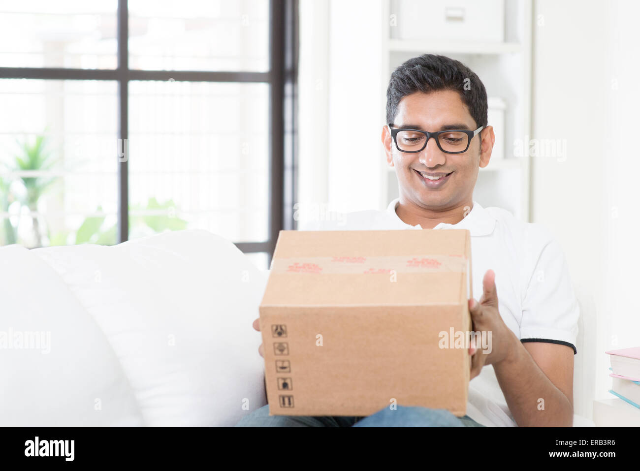 Courier delivery concept. Indian guy received an express parcel and