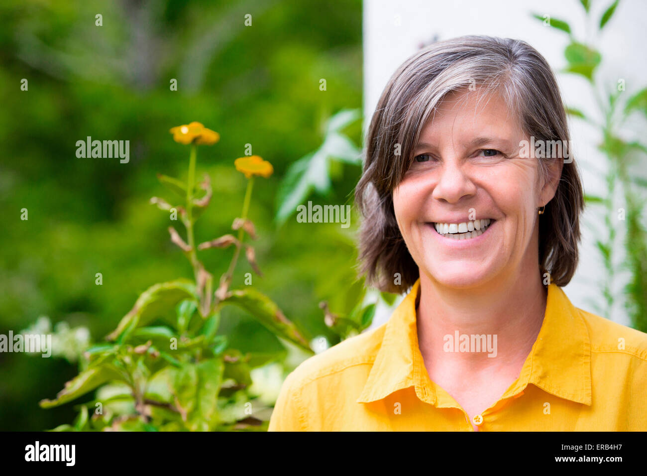 portrait of an older woman on her balcony and smiling Stock Photo - Alamy