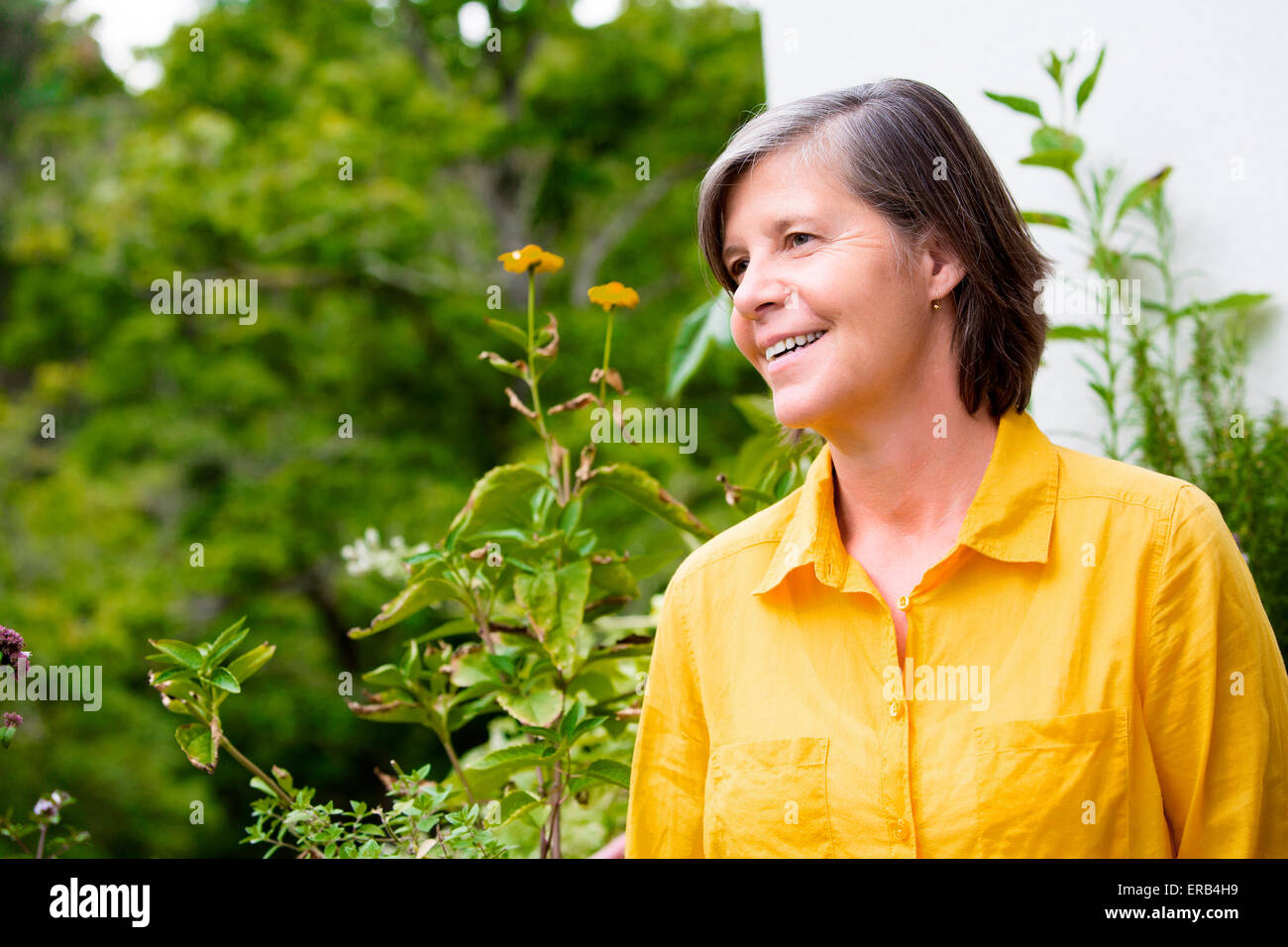 portrait of an older woman on her balcony and smiling Stock Photo - Alamy