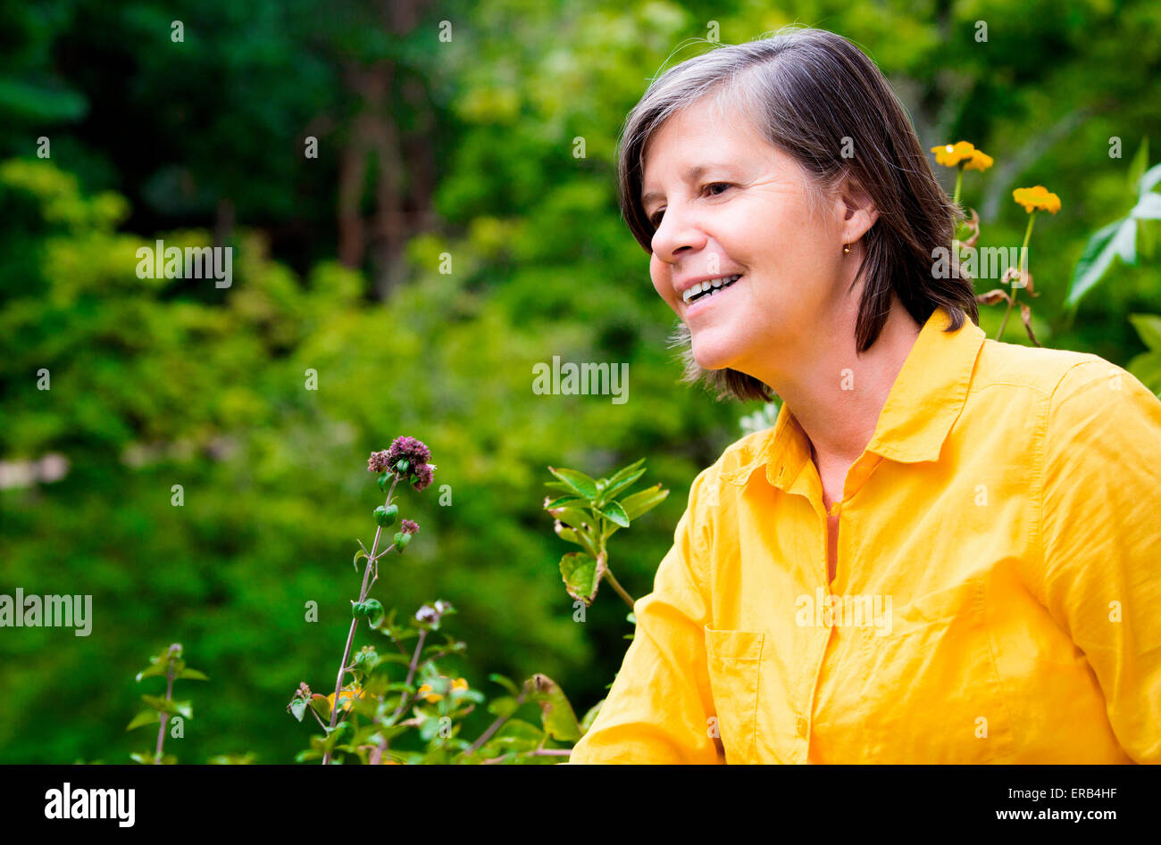 portrait of an older woman on her balcony and smiling Stock Photo - Alamy
