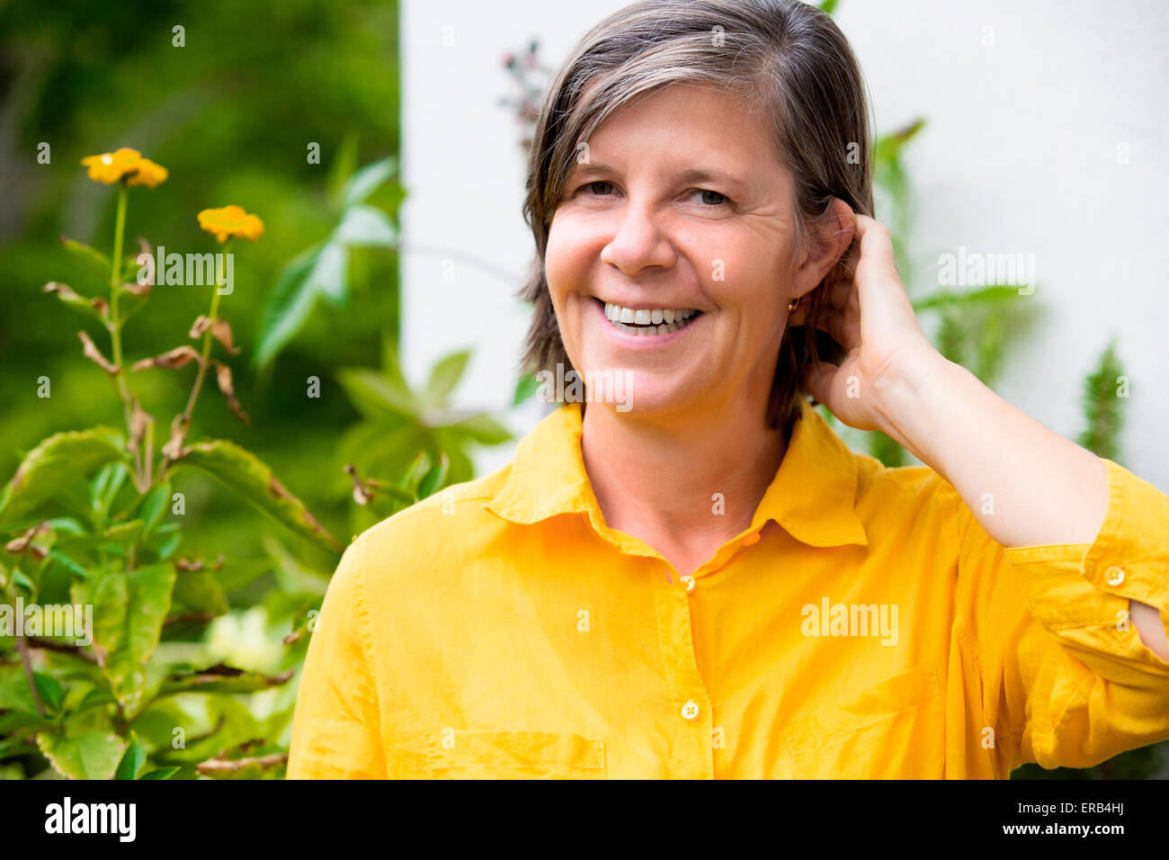 portrait of an older woman on her balcony and smiling Stock Photo - Alamy