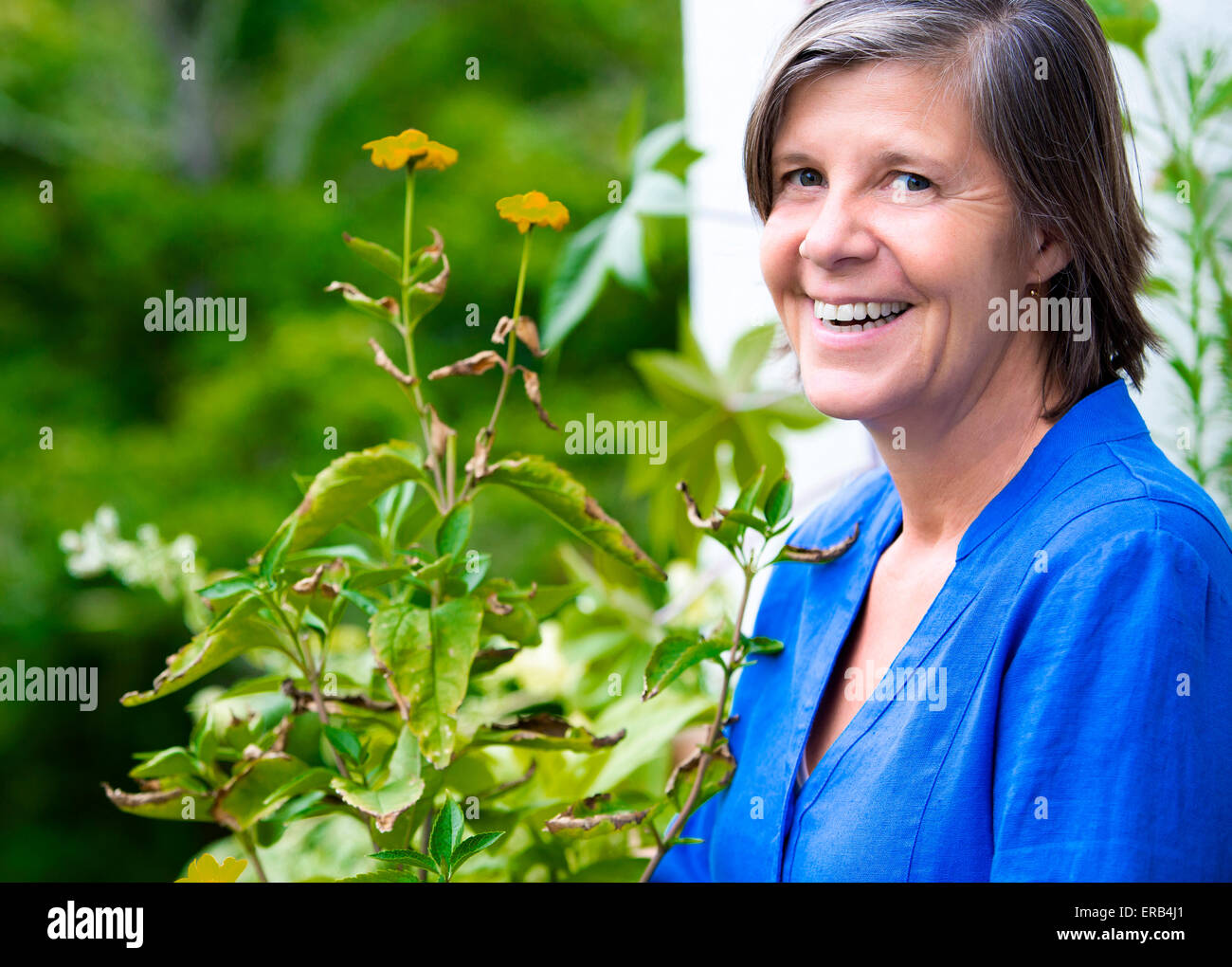 portrait of an older woman on her balcony and smiling Stock Photo - Alamy
