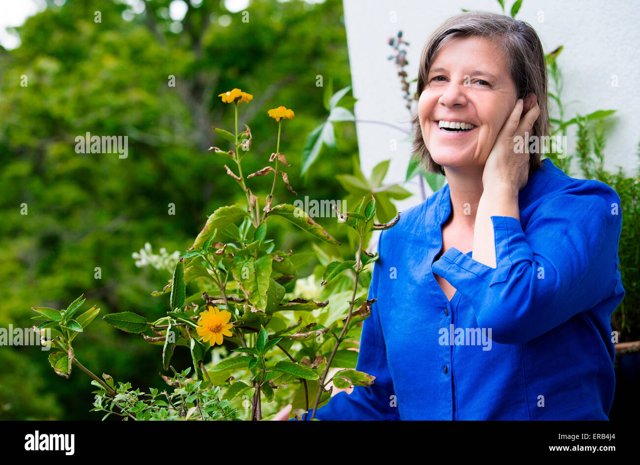 portrait of an older woman on her balcony and smiling Stock Photo - Alamy