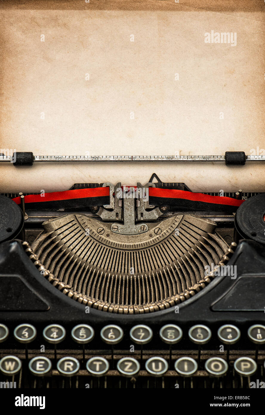 Antique typewriter with aged textured paper sheet with space for your text Stock Photo