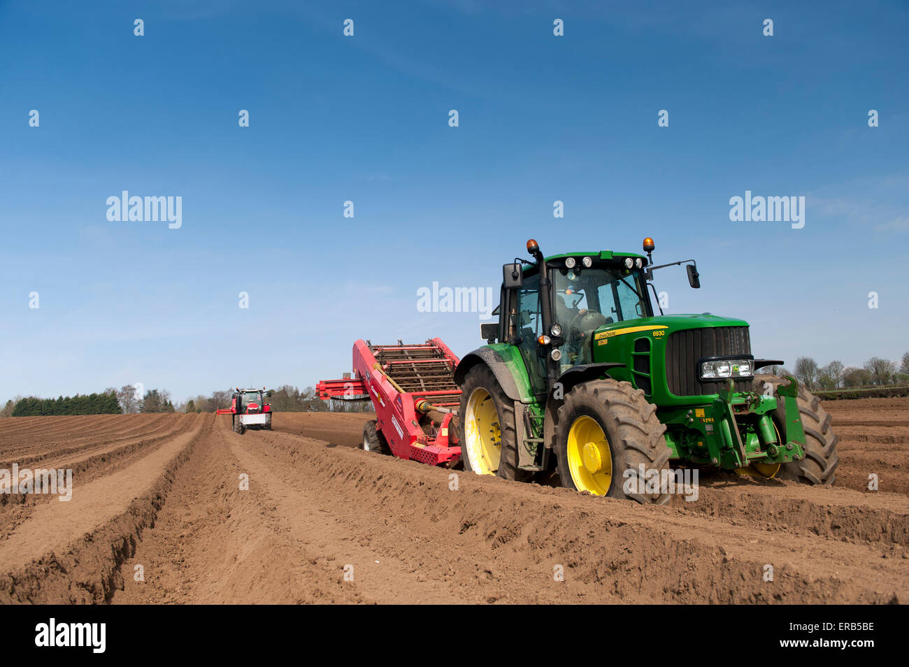 Preparing potato seed bed, using Grimme stone removing machine pulled by a John Deere 6930, Yorkshire, UK. Stock Photo