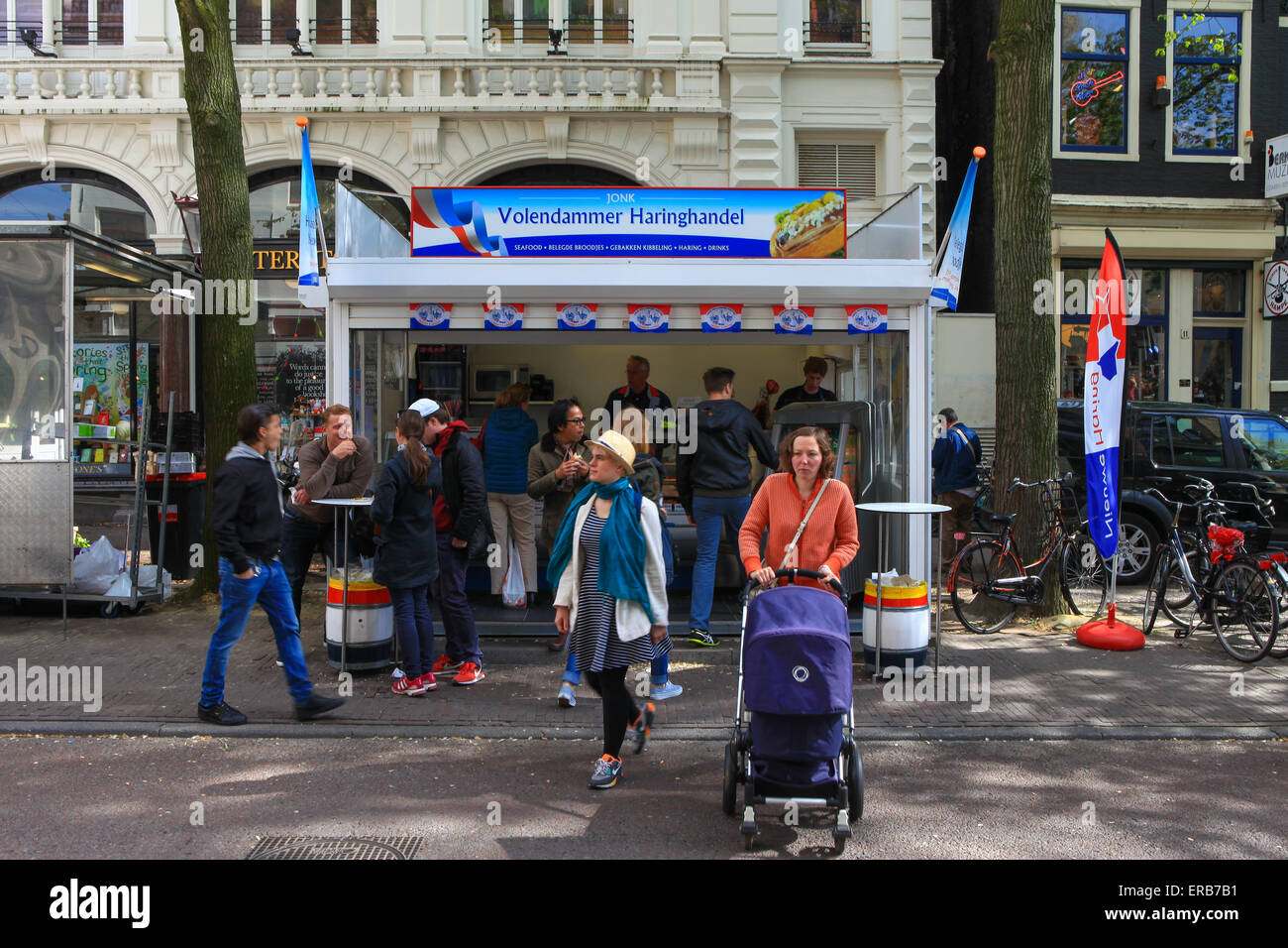 Locals and tourist at one of Amsterdam's famous Herring street shop Stock Photo