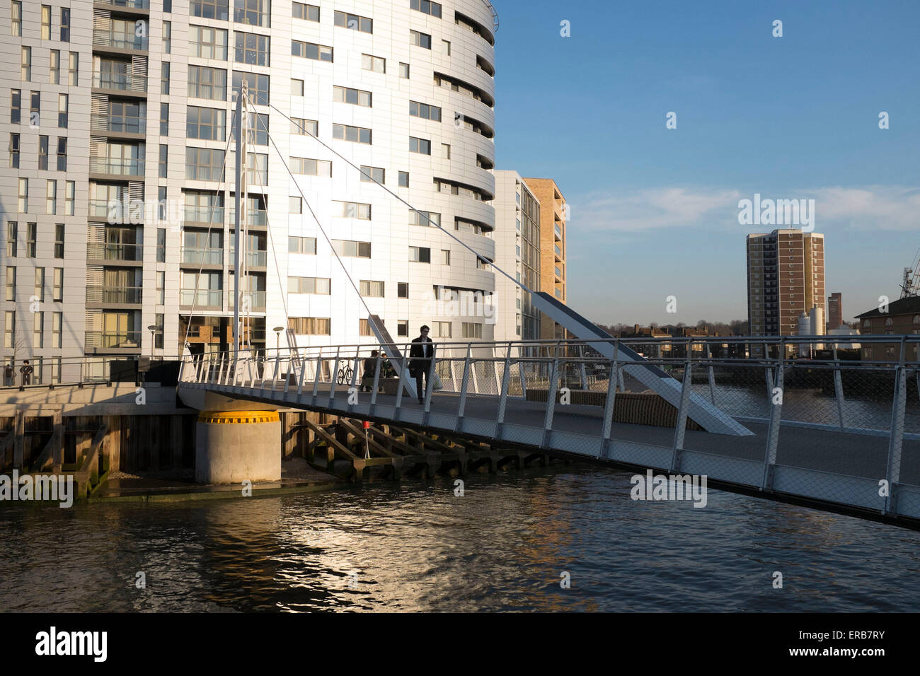 New walkway bridge across the River Thames at Greenwich, allowing pedestrians to cross to a new development. London, UK. Stock Photo