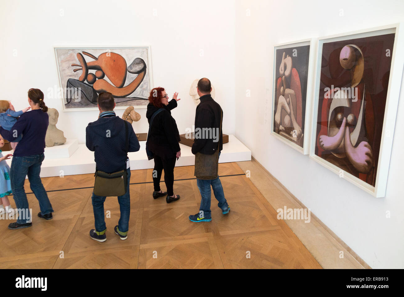 Young Caucasian People In An Art Gallery Looking At Paintings And Talking  About Them Stock Photo, Picture and Royalty Free Image. Image 22573792.