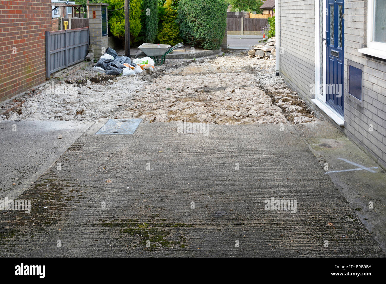 Residential property old concrete car driveway being broken up and prepared for new block paving replacement as home improvement project England UK Stock Photo
