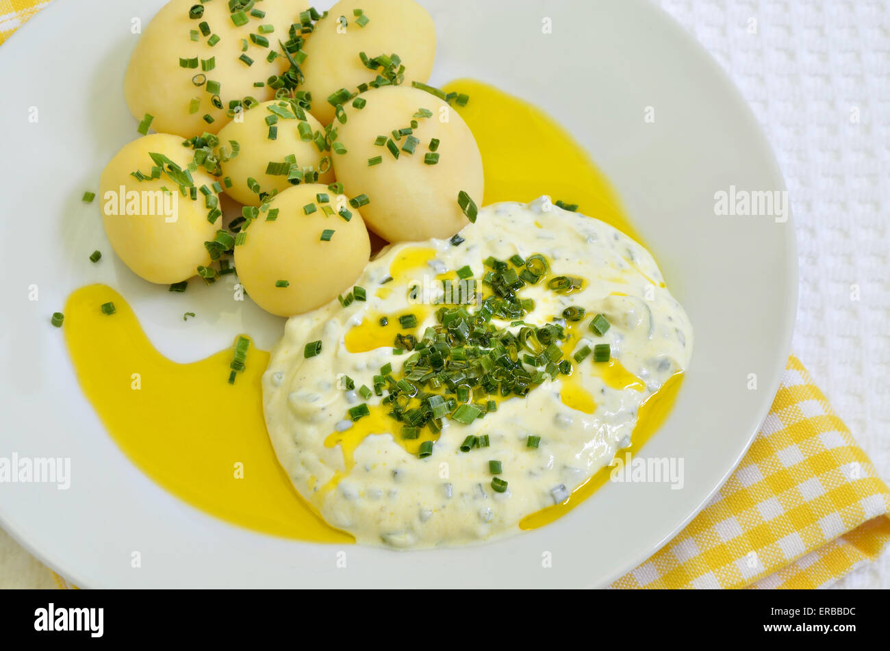 close up of a plate with curd cheese, boiled potatoes, linseed oil and chive, macro, detail, full frame,  horizontal Stock Photo