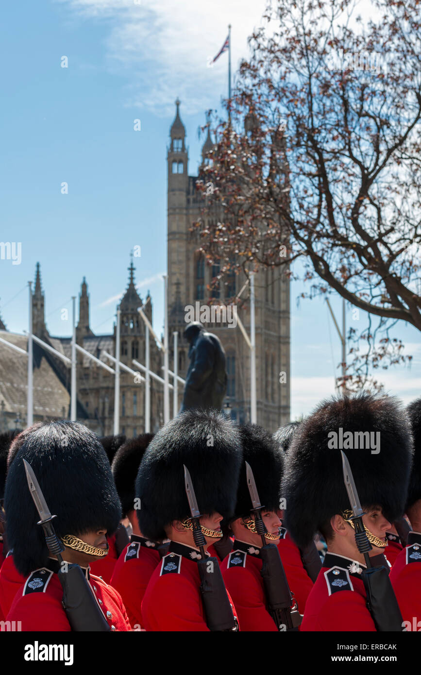 Soldiers from the Grenadier Guards in ceremonial red uniforms on duty at the State Opening of Parliament on a sunny day Stock Photo