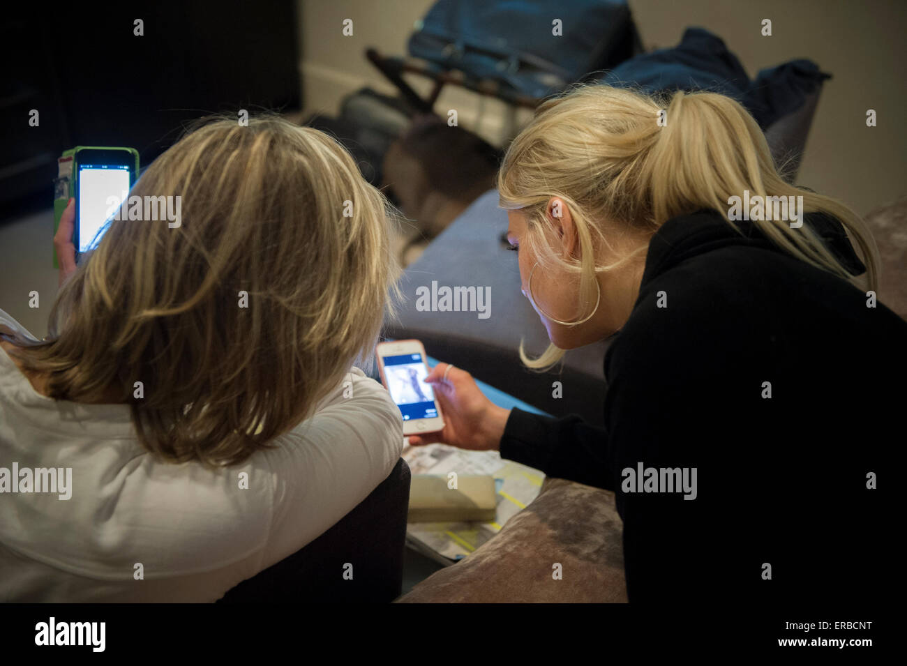 Family members enjoying a tablet and smart phone Stock Photo