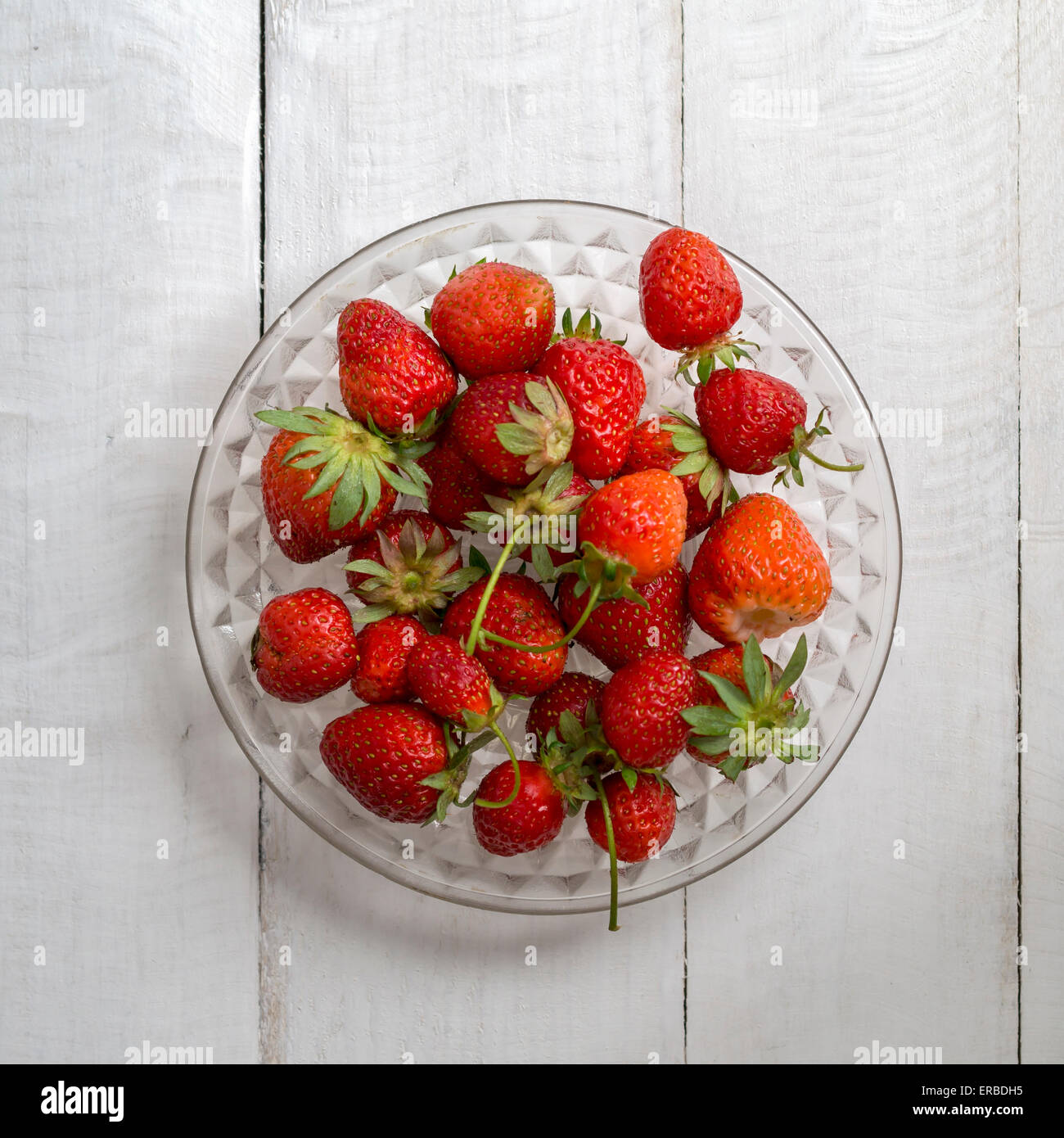 Organic ripe juicy strawberries on wooden table, from above Stock Photo