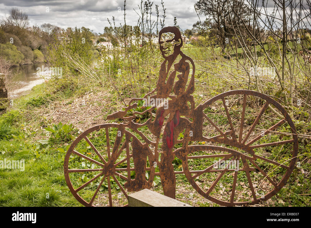 Portrait bench cast iron figure sculpture of Kirkpatrick Macmillan - often cited as the inventor of the bicycle, erected in time Stock Photo