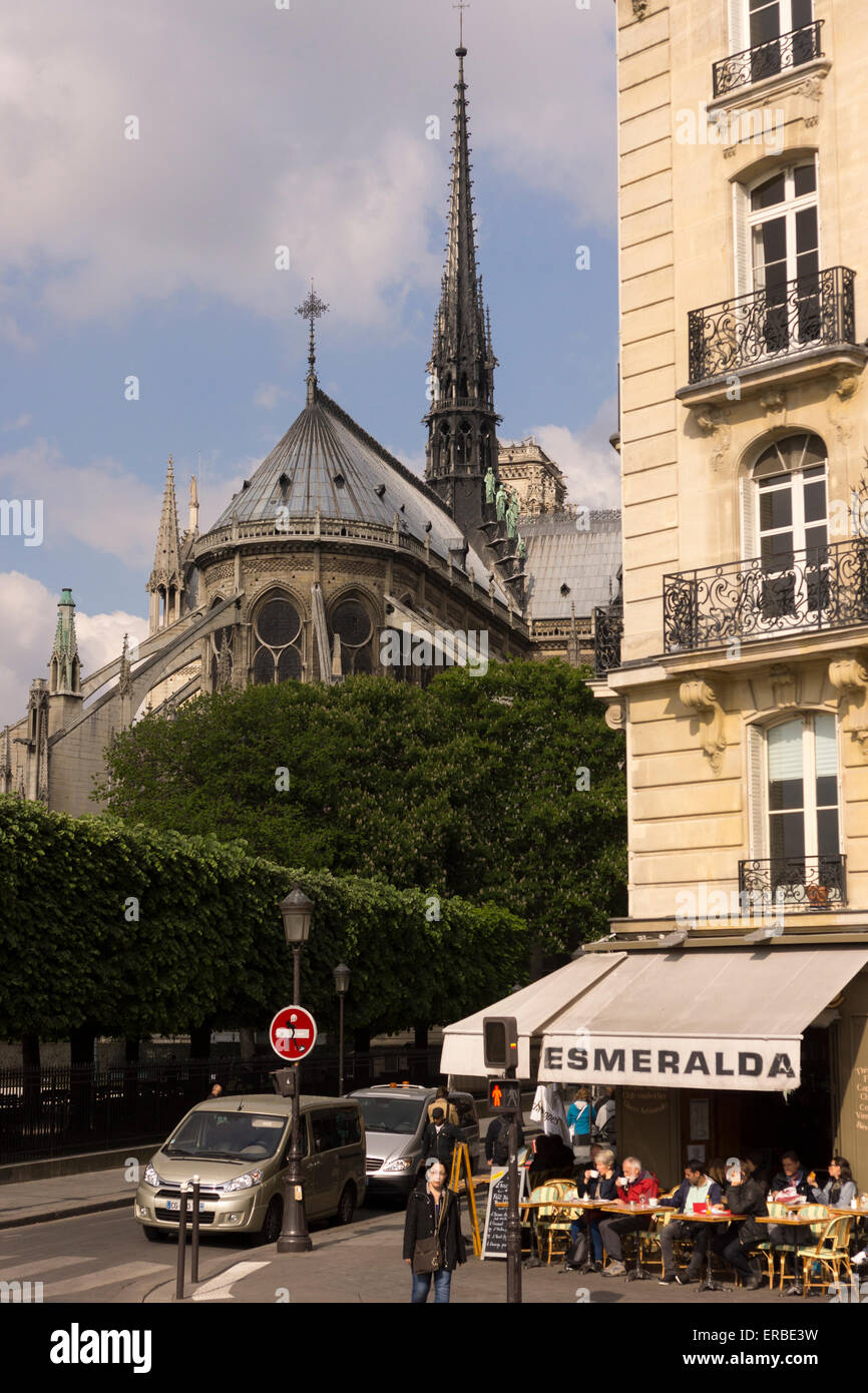 A view of Esmerelda French cafe and the east facade of the medieval gothic Notre Dame cathedral, Paris, as seen from Pont Saint Louis. France Stock Photo
