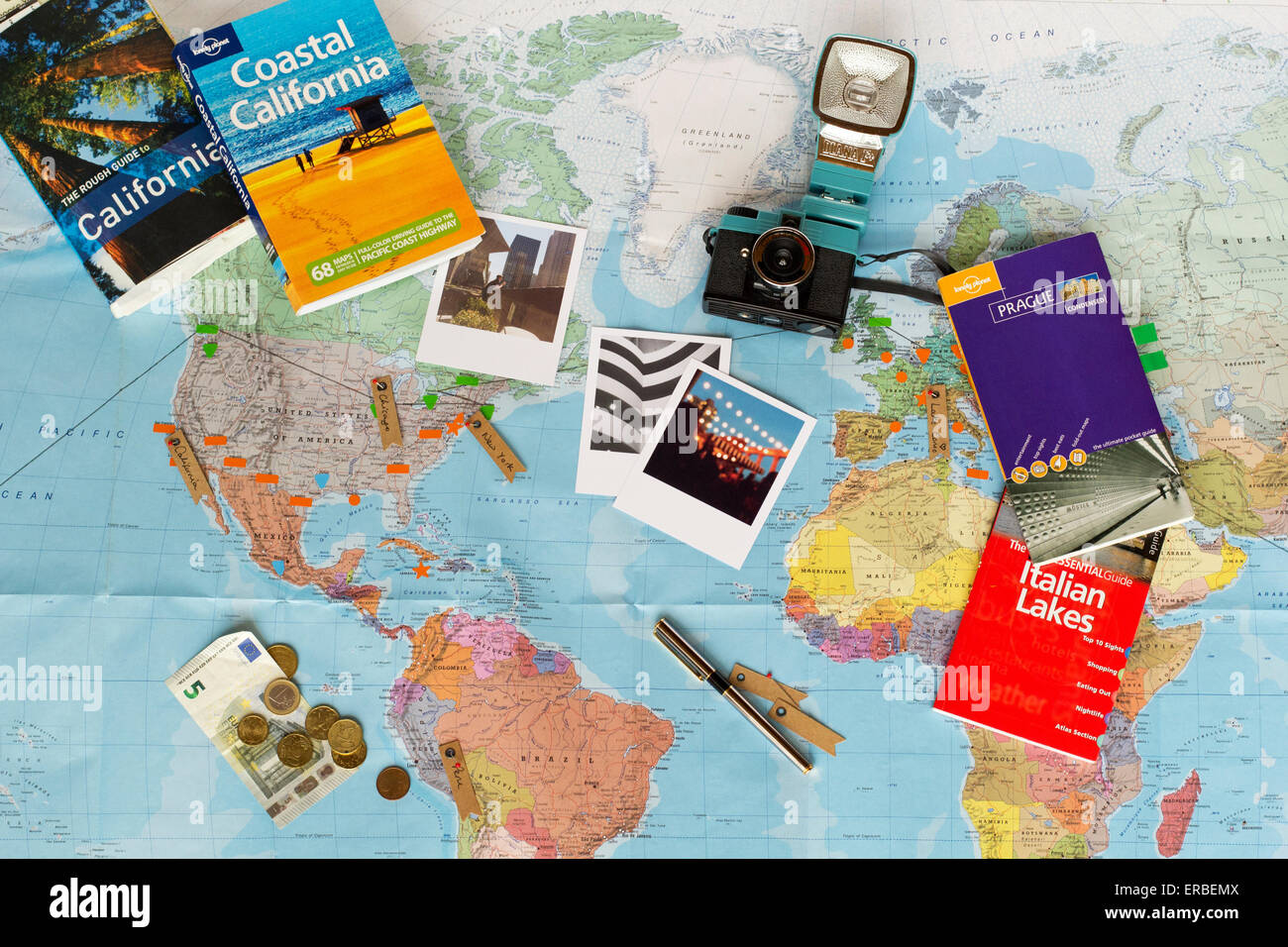 Travel planning. Map of the world, guide books, currency, photographs Stock  Photo - Alamy