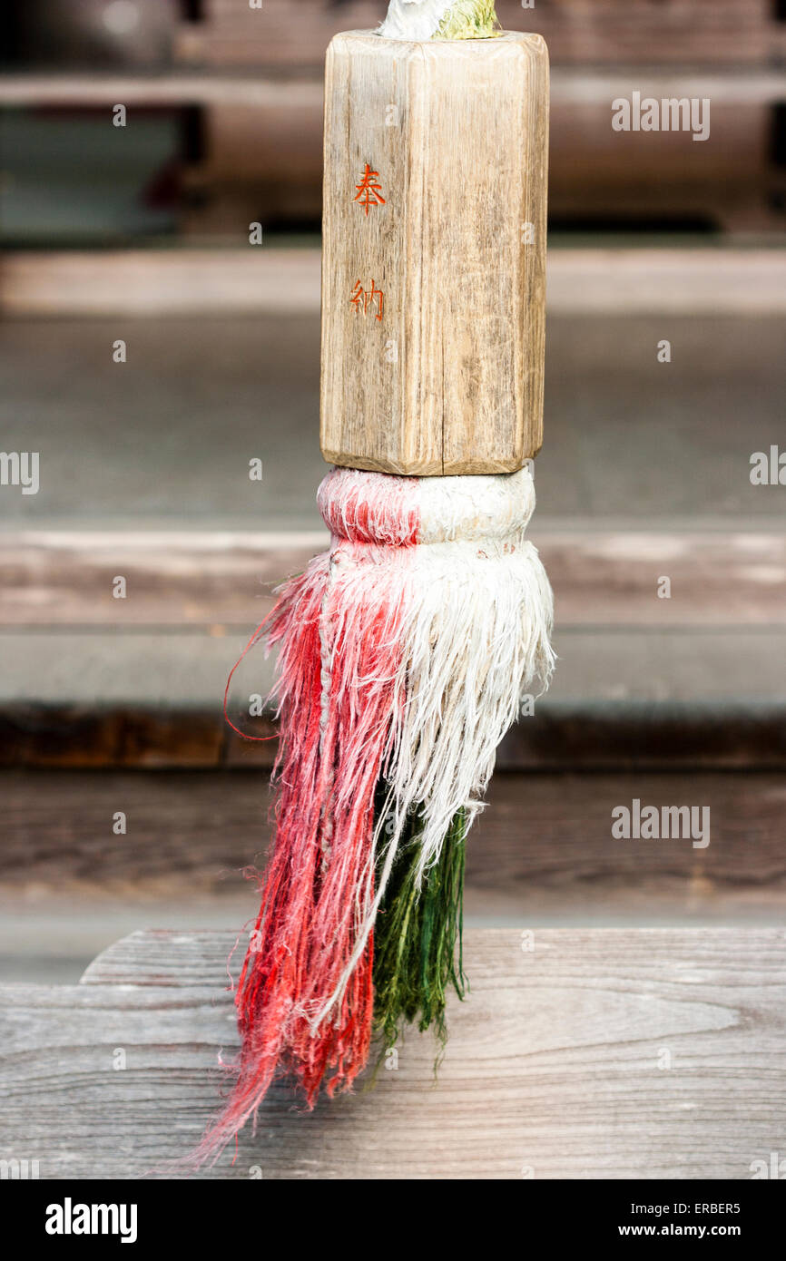 Japan, Kyoto, Nanzen temple, Saisho-in, sub temple. Hemp bell rope with wooden gripper with red kanji character inscription painted on. Stock Photo