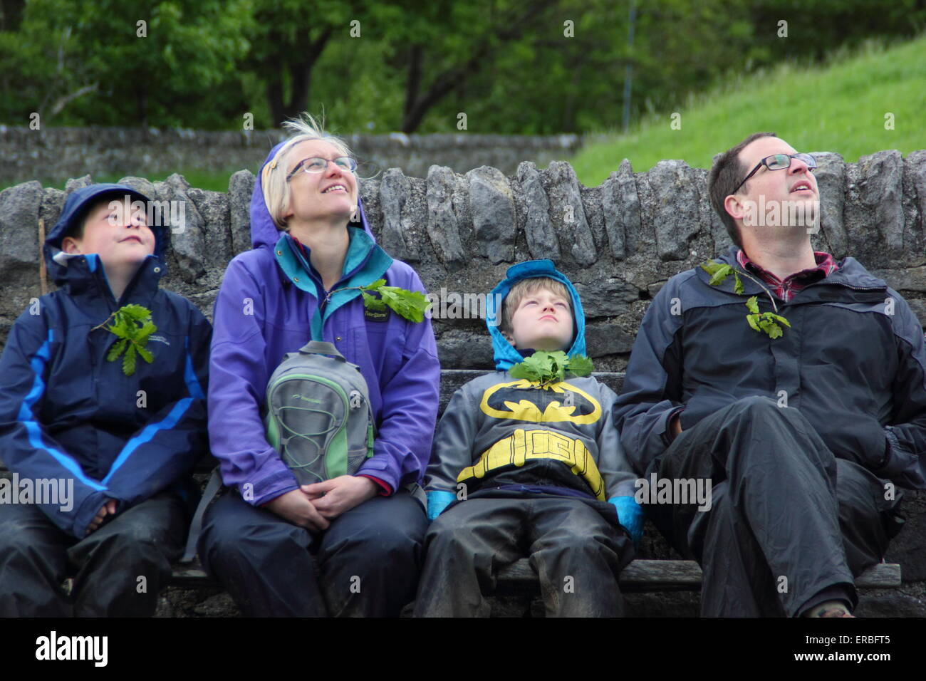 A family look up to the sky  during a game of identifying shapes in clouds in the Peak District National Park Derbyshire  UK Stock Photo